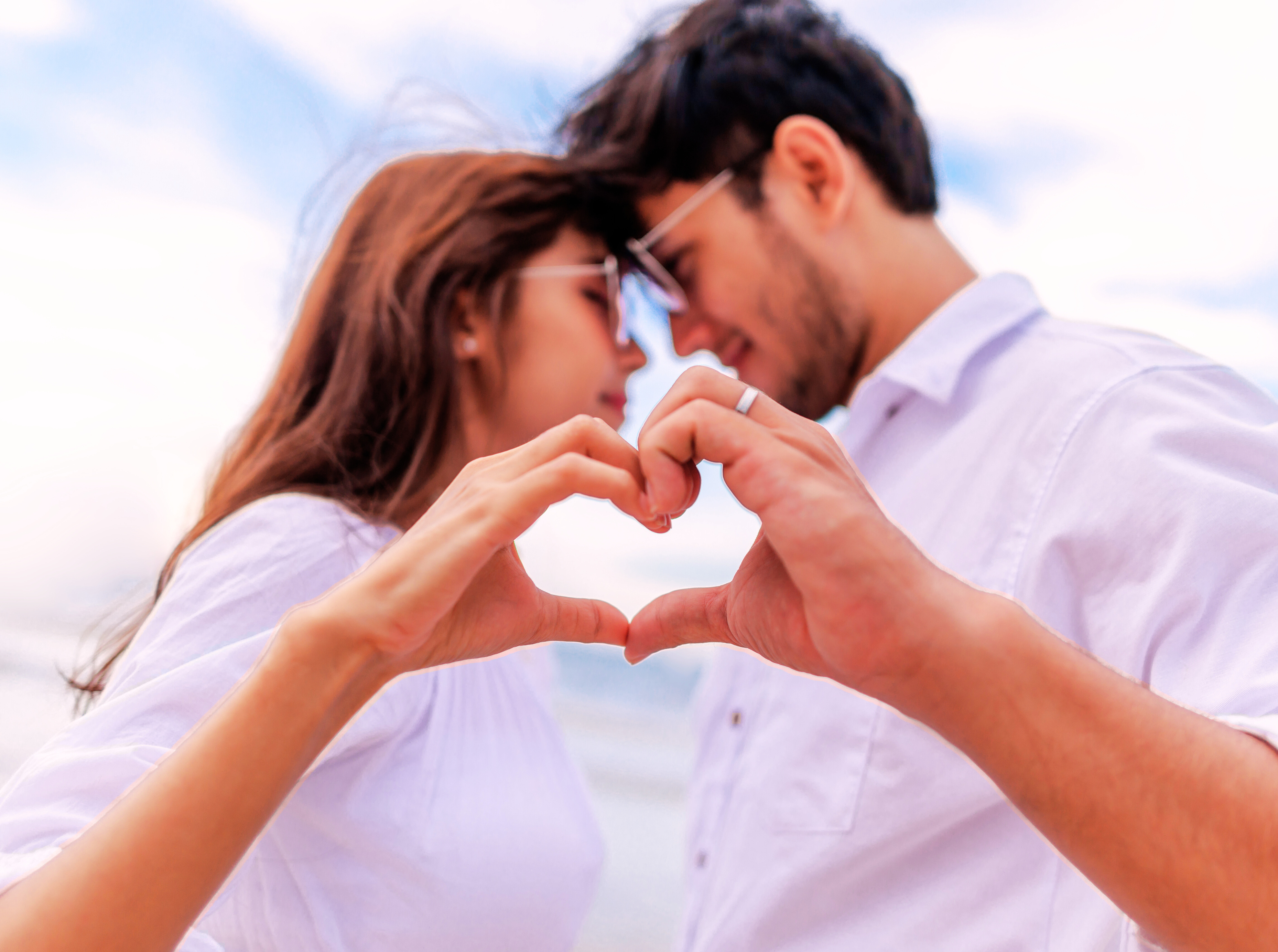 Couple Making Heart Shape with Hands